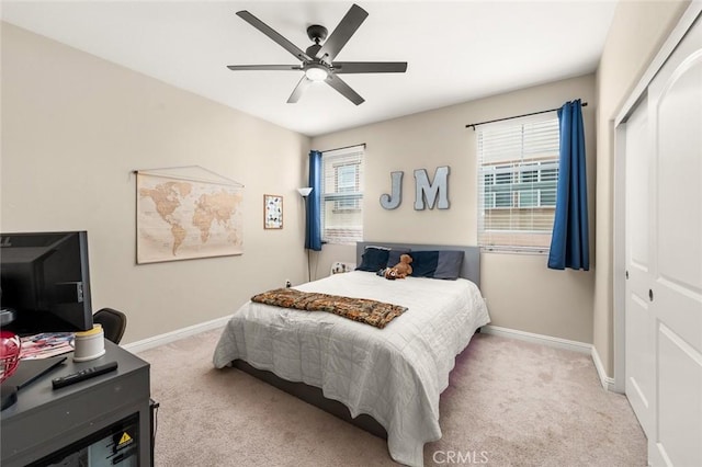 bedroom with light carpet, a closet, and ceiling fan