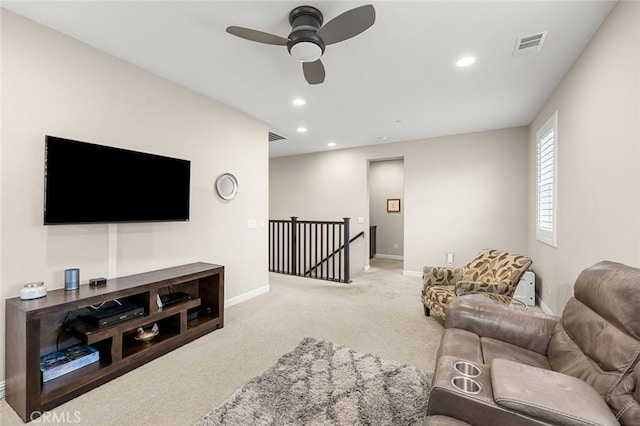 carpeted living room with ceiling fan