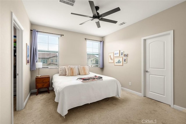 bedroom featuring ceiling fan and light carpet