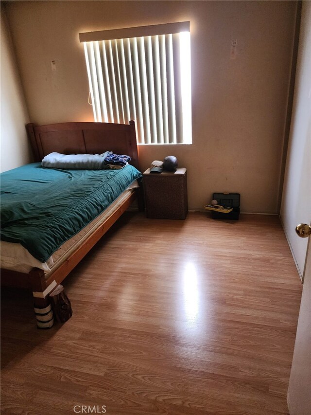 bedroom with wood-type flooring