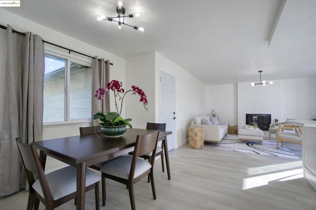 dining space with an inviting chandelier and light hardwood / wood-style floors