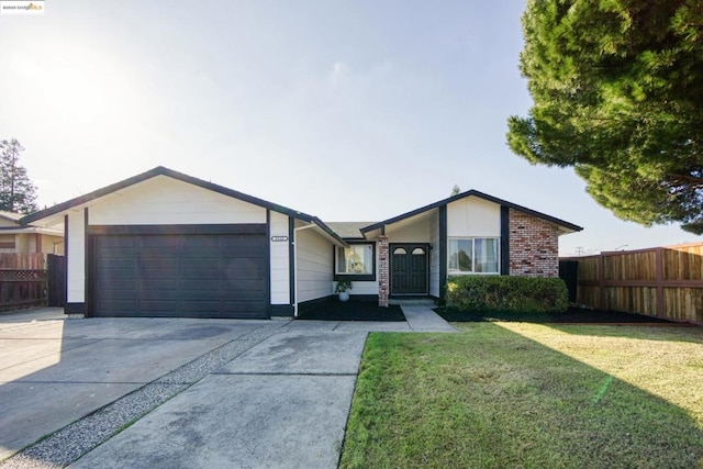 ranch-style house featuring a garage and a front lawn