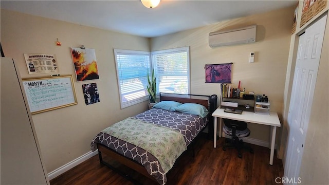 bedroom featuring dark wood-type flooring and a wall mounted AC