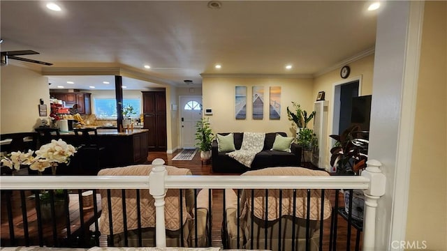 living room with ornamental molding, dark hardwood / wood-style flooring, and ceiling fan