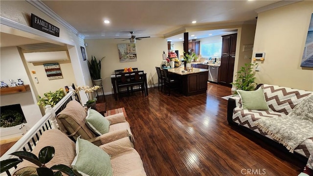 living room with crown molding, ceiling fan, and dark hardwood / wood-style flooring