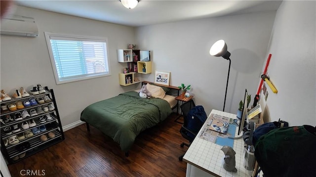 bedroom with dark wood-type flooring and a wall unit AC