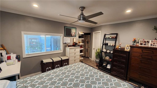 bedroom featuring hardwood / wood-style floors, ornamental molding, and ceiling fan