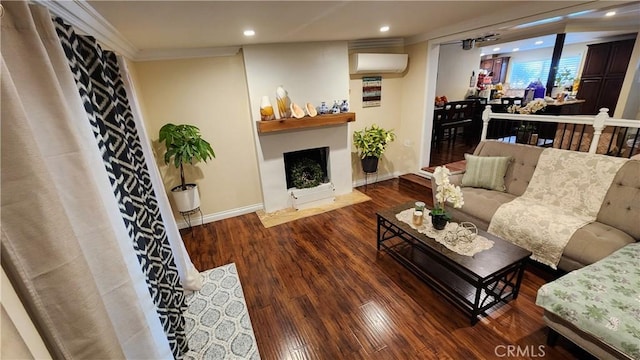 living room featuring dark hardwood / wood-style floors and a wall unit AC