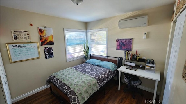 bedroom featuring dark hardwood / wood-style floors and a wall mounted AC