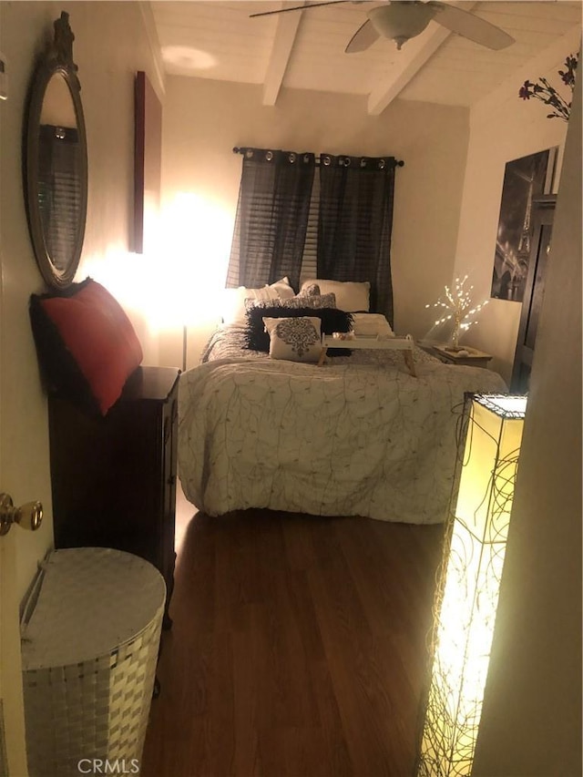 bedroom with beamed ceiling, ceiling fan, and dark hardwood / wood-style flooring