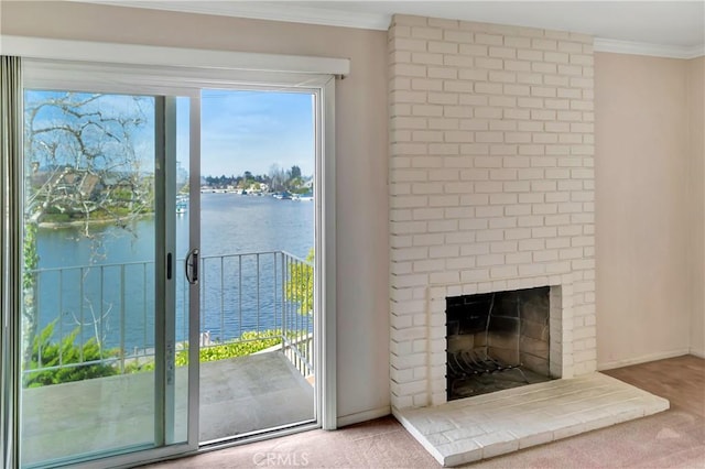 doorway featuring ornamental molding, a water view, carpet flooring, and a fireplace