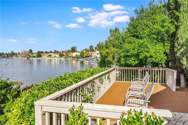 wooden deck featuring a water view