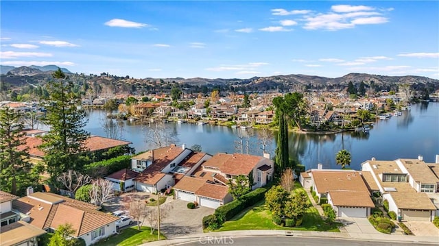 drone / aerial view featuring a water and mountain view