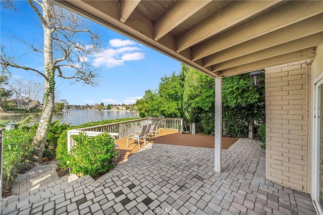 view of patio / terrace featuring a deck with water view