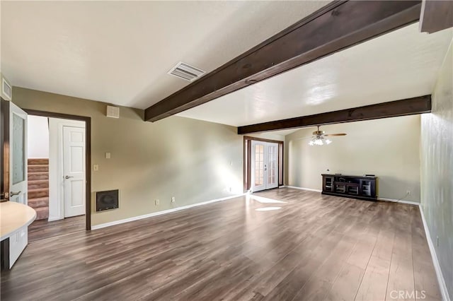 unfurnished living room featuring ceiling fan, wood-type flooring, and beamed ceiling