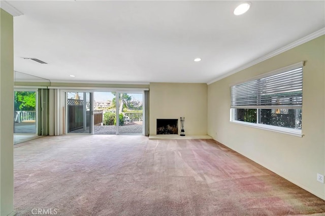 unfurnished living room with light colored carpet and ornamental molding