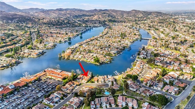 birds eye view of property with a water and mountain view