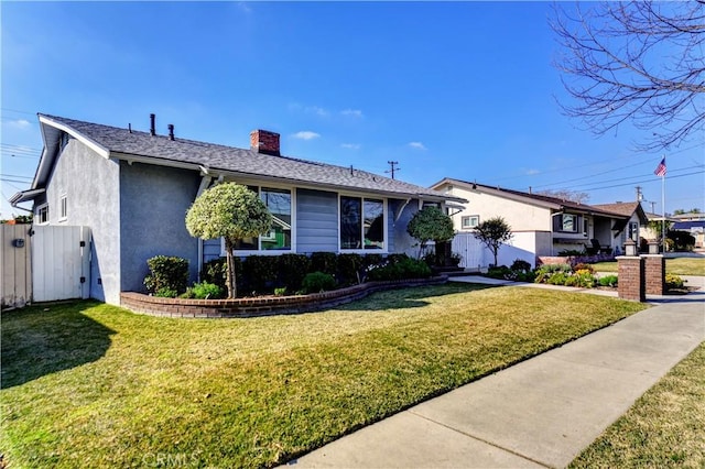 ranch-style home with a front lawn