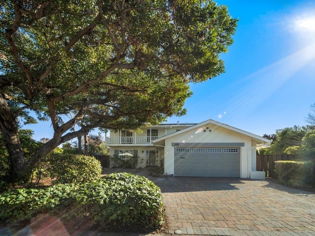 view of front of property featuring a garage and a balcony