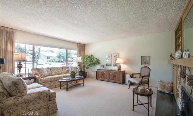 carpeted living room featuring a stone fireplace and a textured ceiling