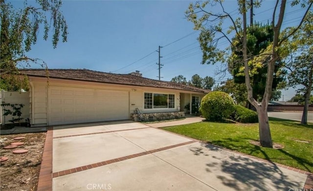 ranch-style home featuring a garage and a front lawn