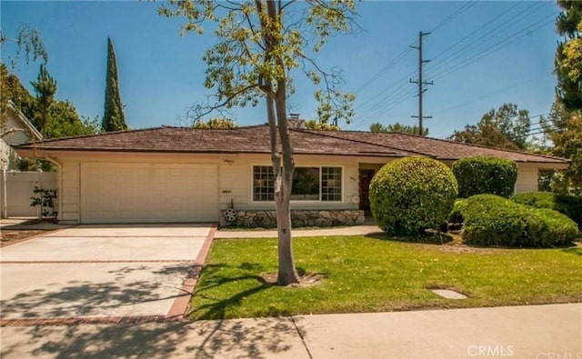 single story home with a garage and a front yard