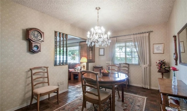 dining area featuring dark parquet flooring, a notable chandelier, and a textured ceiling