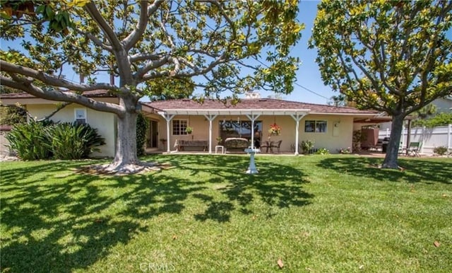 rear view of house with a yard