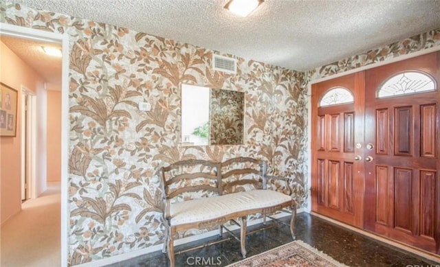 entrance foyer with a textured ceiling