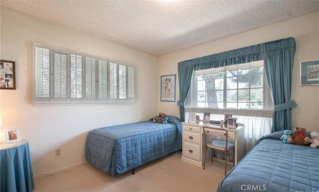 carpeted bedroom featuring a textured ceiling