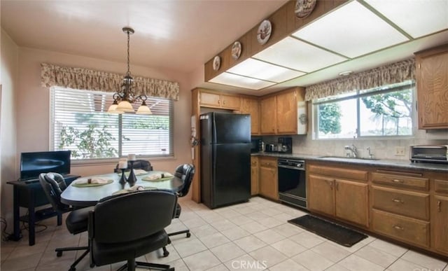 kitchen with plenty of natural light, sink, decorative backsplash, and black appliances