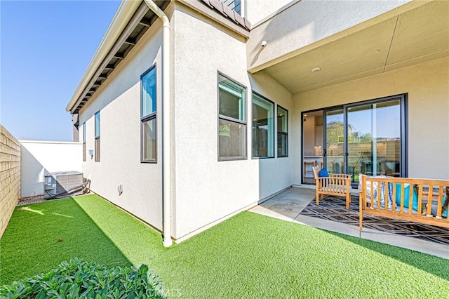 exterior space with central AC unit and a patio area