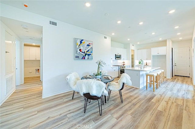 dining area featuring light wood-type flooring