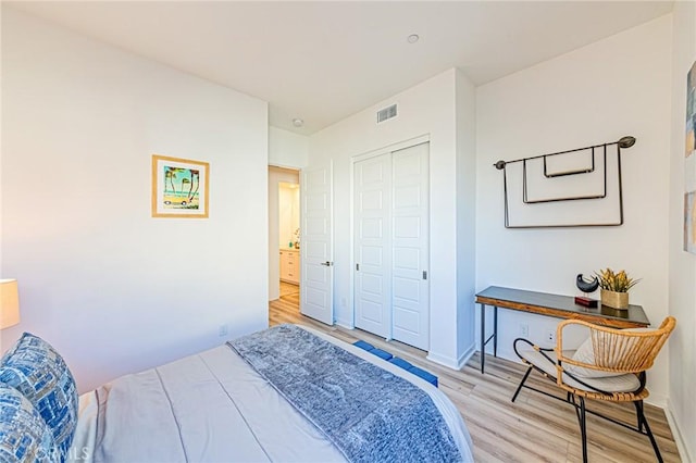 bedroom featuring light wood-type flooring and a closet