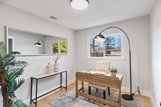 office area with light hardwood / wood-style floors