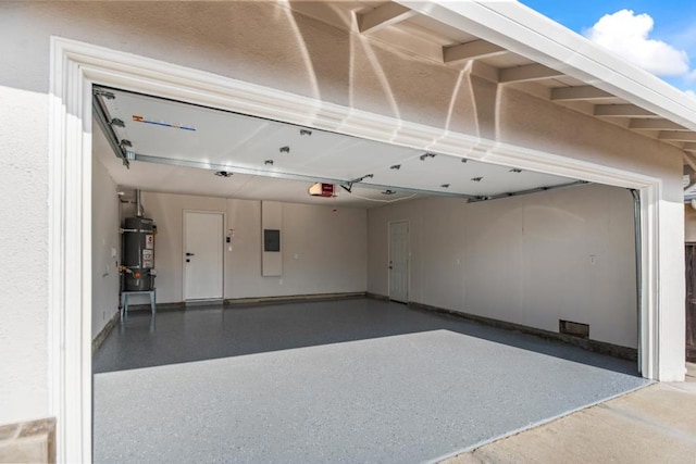 garage with a garage door opener and secured water heater