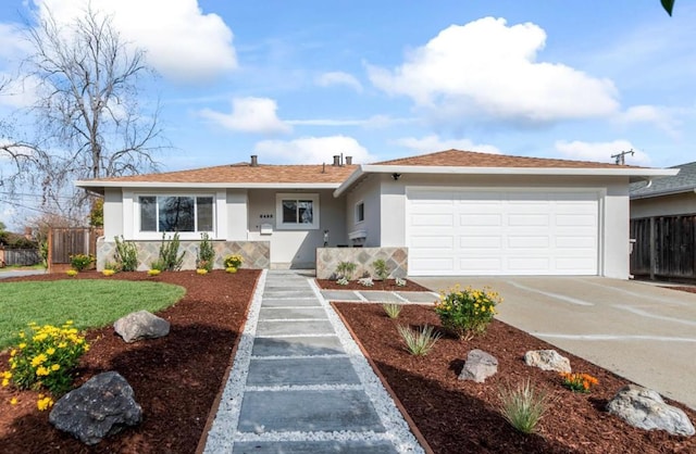 single story home featuring a garage and a front lawn