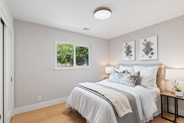 bedroom featuring hardwood / wood-style floors and a closet