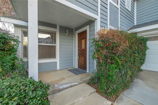 doorway to property with a garage