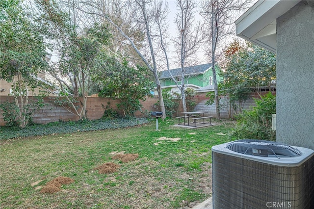 view of yard with a fenced backyard and central air condition unit