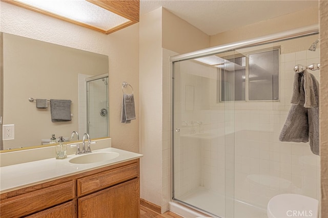 full bath featuring a shower stall and vanity