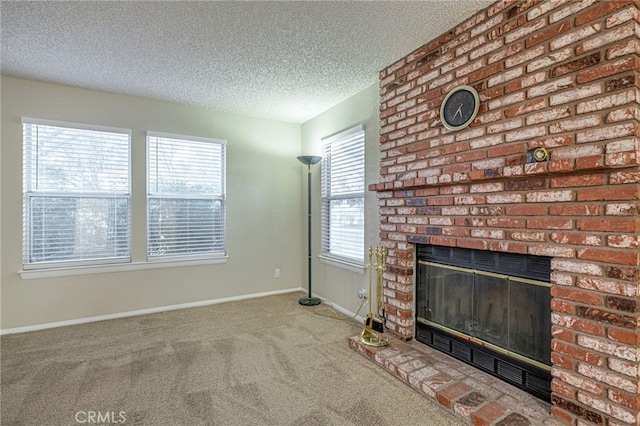 unfurnished living room featuring a textured ceiling, a brick fireplace, carpet flooring, and baseboards