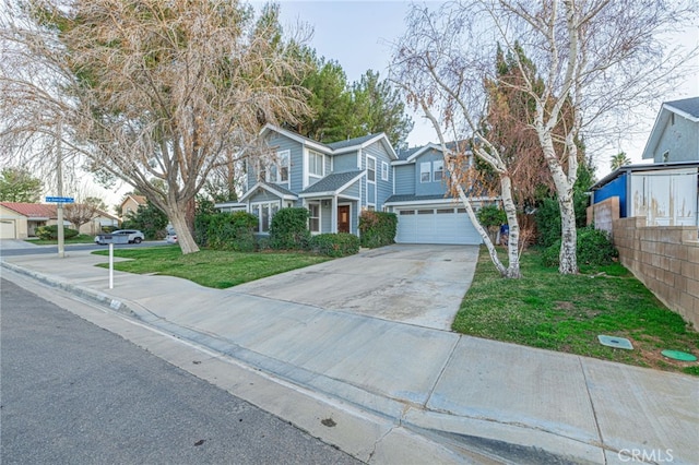 view of front of house featuring a garage, fence, concrete driveway, a residential view, and a front lawn