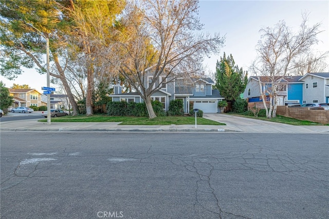 view of front facade with concrete driveway, an attached garage, and a residential view