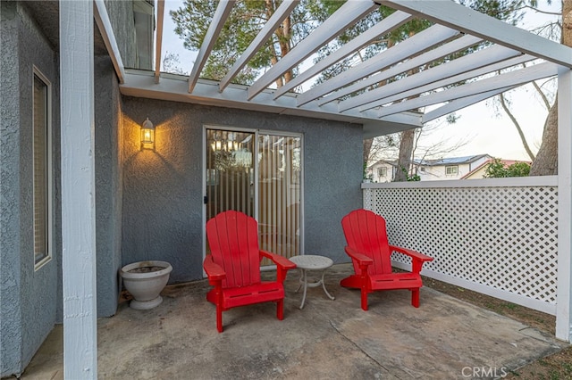 view of patio featuring fence and a pergola