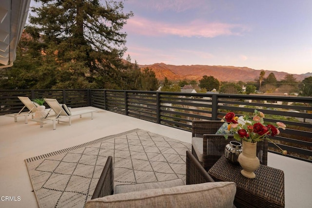 patio terrace at dusk with a mountain view