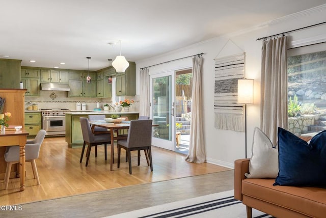 dining room featuring crown molding and light hardwood / wood-style flooring