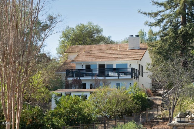 back of house with a balcony