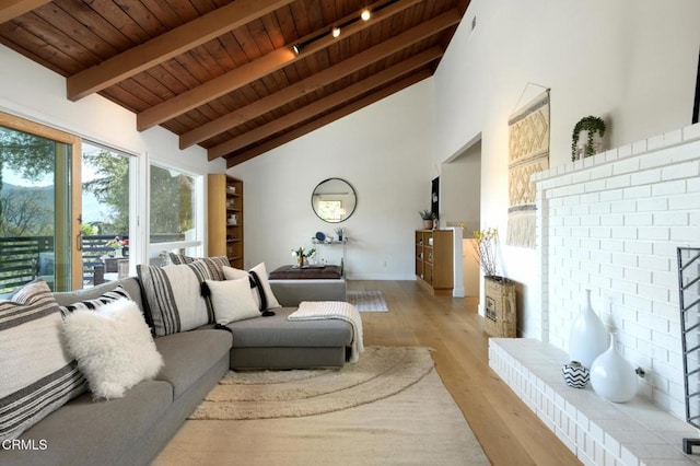 living room featuring high vaulted ceiling, beam ceiling, wooden ceiling, and light wood-type flooring