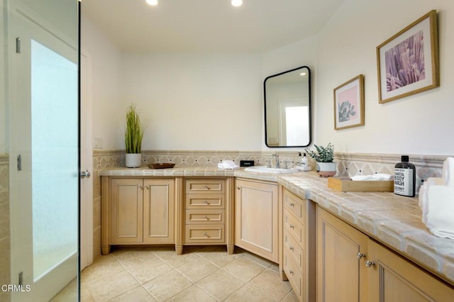 bathroom with tile patterned floors and vanity